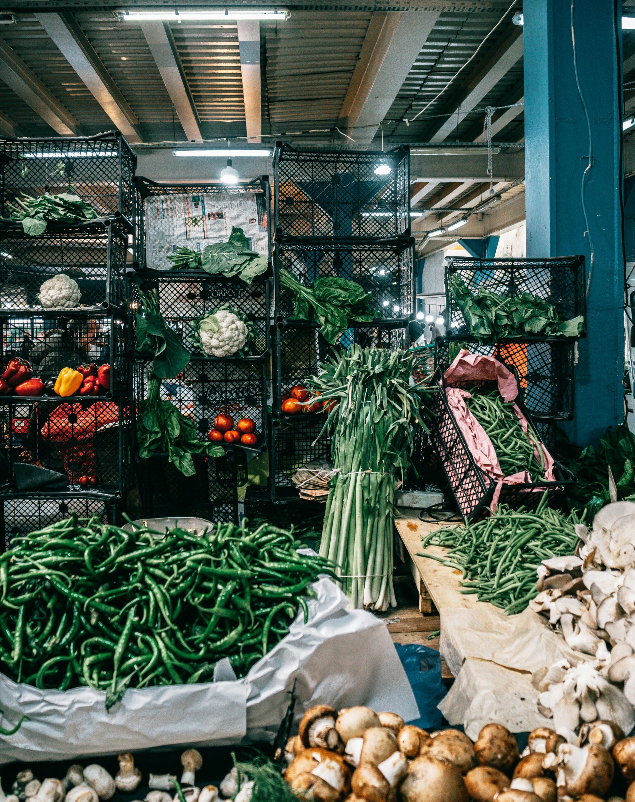 Indoor market in Istanbul showcasing fresh vegetables like peppers and mushrooms.